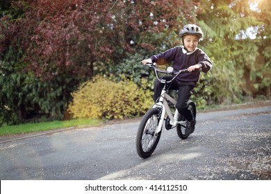 Boy Learning To Ride His Bike Home From School