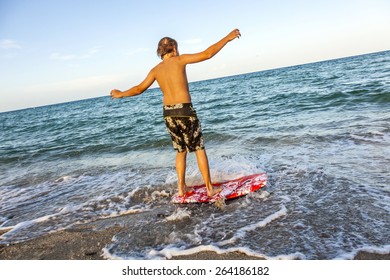 boy learning surfing at the beach