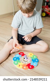 Boy Learning Time With Wooden Clock. Toy For Learning Method For Children Education. Preschool Or Special Needs Tasks. Montessori Methodology.