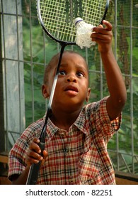 boy learns to play badminton