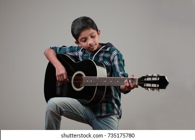 Boy Learns To Play A Guitar