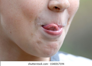 The Boy Licks His Lips, Traces Of Milk On His Upper Lip, Close-up, Smiling