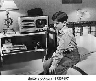 Boy Listening To Radio In Bedroom