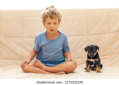 A Boy With A Little Dog Doing Yoga