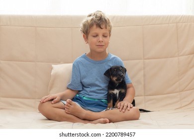 A Boy With A Little Dog Doing Yoga