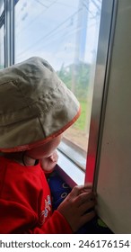 boy looking out at the train window 