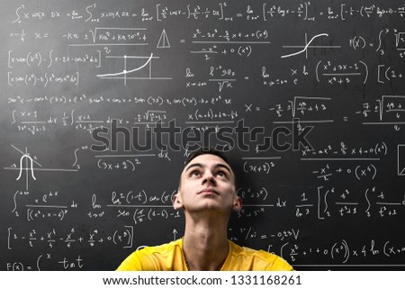 a Boy looks apprehensively at a mathematical formula