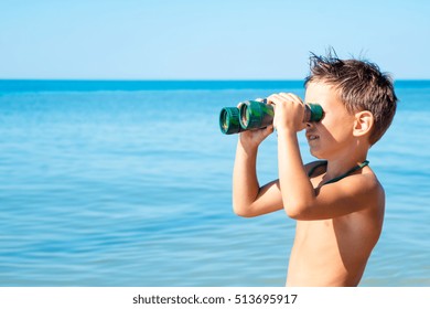 boy looks through binoculars and sees sea - Powered by Shutterstock