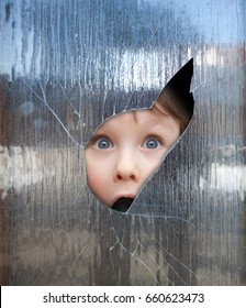 Boy Looks Through A Broken Window