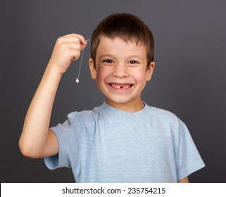 Boy With Lost Tooth On A Thread