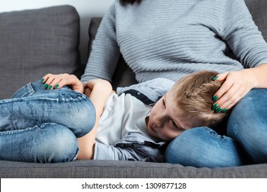 The Boy Is Lying On The Couch With An Abdominal Pain Near His Mother. The Concept Of Custody, Parental Care, Stomach Problems, Food Poisoning, Problems In Children.