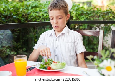 Boy Made Grimace And Refuses To Eat Salad. Child Has No Appetite And He Refuses To Eat Healthy Food