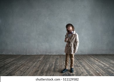 Boy with a magnifying glass in studio - Shutterstock ID 511129582