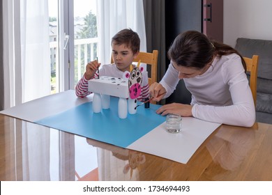 Boy Makes Easy Cow Paper Craft, Mother Helping Her Son To Do Homework, Parents Teaching Kids At Home, Boy Painting Paper Cow Craft, Stay Together