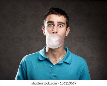 Boy Making A Bubble From A Chewing Gum 