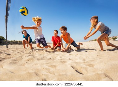 Boy making bump pass during beach volleyball game - Powered by Shutterstock