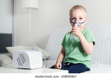 Boy Making Inhalation With Nebulizer At Home. Child Asthma Inhaler Inhalation Nebulizer Steam Sick Cough Concept