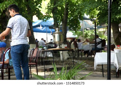 A Boy Making A Samovar Tea In A Cafe In Sheki. 19.07.2019 Sheki. Azerbaijan