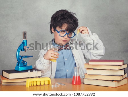 Image, Stock Photo boy is making science experiments in a laboratory