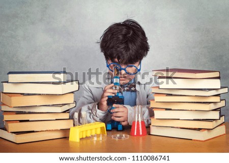 Similar – Image, Stock Photo boy is making science experiments in a laboratory