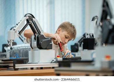 Boy male teen child concentrate enjoy Machine Learning Robot is Moving Under Control robot coding at technology stem class, stem education robot for digital automation artificial intelligence ai - Shutterstock ID 2364466611