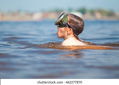 Boy In A Mask For Diving Takes A Deep Breath. Child Takes A Deep Breath Mouth Before Snorkeling Into The Water. Side View