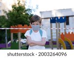 the boy in mask does not like closed playgrounds  due  pandemic coronavirus