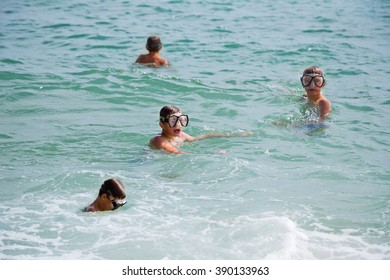 Boy In A Mask Floats In The Sea. This Is The Same Boy From Different Angles.