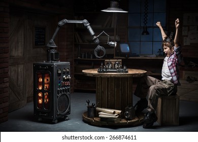 Boy Mechanic Robot Helper Playing Chess In The Studio In The Evening