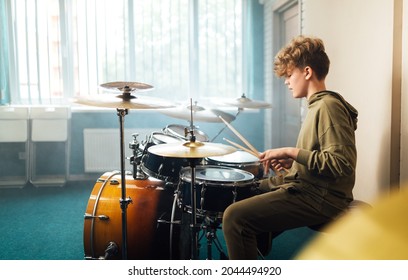 Boy musician behind a drum kit.