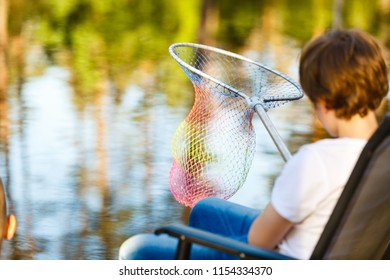 A Boy With A Net Catch Fish