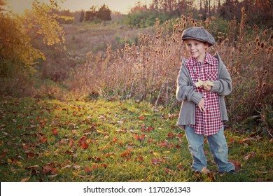 Boy In Newsboy Cap In Autumn Field