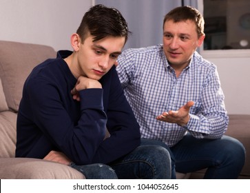 Boy is offended and father is asking for his forgiveness at the home.