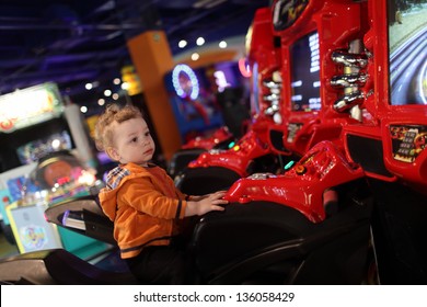 Boy On Amusement Bike At Indoor Playground