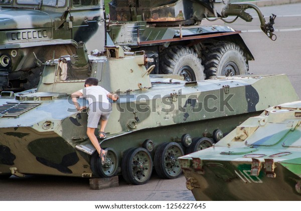 boy on an armored\
personnel carrier