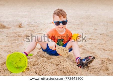 Similar – Image, Stock Photo Small child buried in the sand of the beach