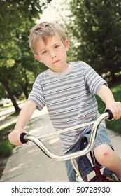 Boy On A Bike With A Scraped Knee