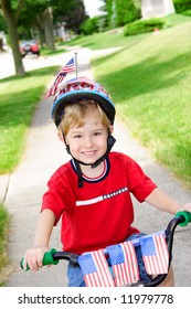 Boy On A Decorated Bike On The 4th Of July