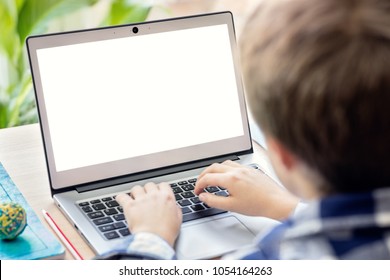 Boy on the internet with laptop computer doing homework with blank screen