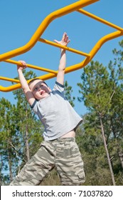 Boy On Monkey Bars At Park