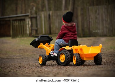 Boy On A Toy Tractor
