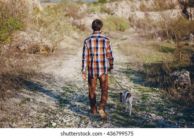 Boy On A Walk In The Woods With The Dog