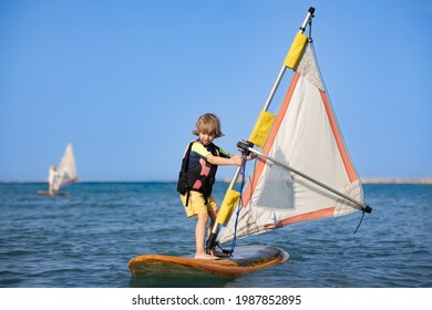 Boy On A Windsurfing Board In The Ocean.