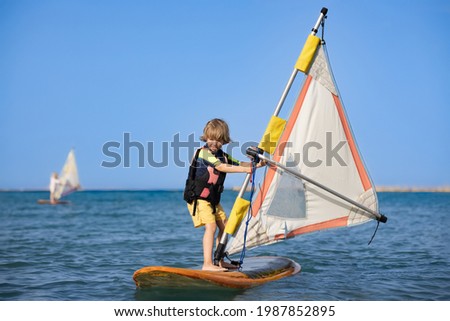 Boy on a windsurfing board in the ocean. Foto d'archivio © 