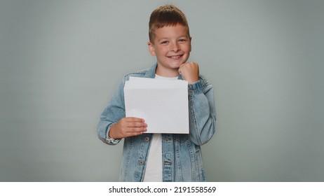 Boy Open Envelope Take Out Letter Reads It Feel Happy. Career Growth Advance Promotion, Bank Loan Approve, Monetary Award Long-awaited Invitation Great News. Child Isolated On Gray Studio Background