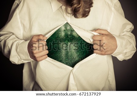 Boy opening shirt to reveal bizarre lizard skin for concept about science fiction alien transformations