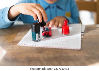 Boy Paints The Car. Nail Polish.