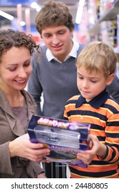 Boy With Parents With Toy In Shop