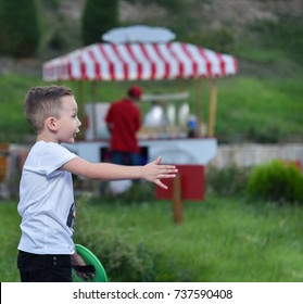 The Boy At The Park Pulled The Hand Throwing The Ball, The Game - Catch The Ball With Plate