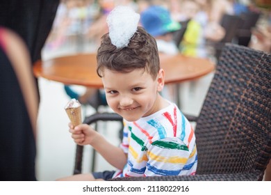 A Boy At A Performance With Ice Cream In His Hands And Soapy Foam On His Head. Kids Foam Party